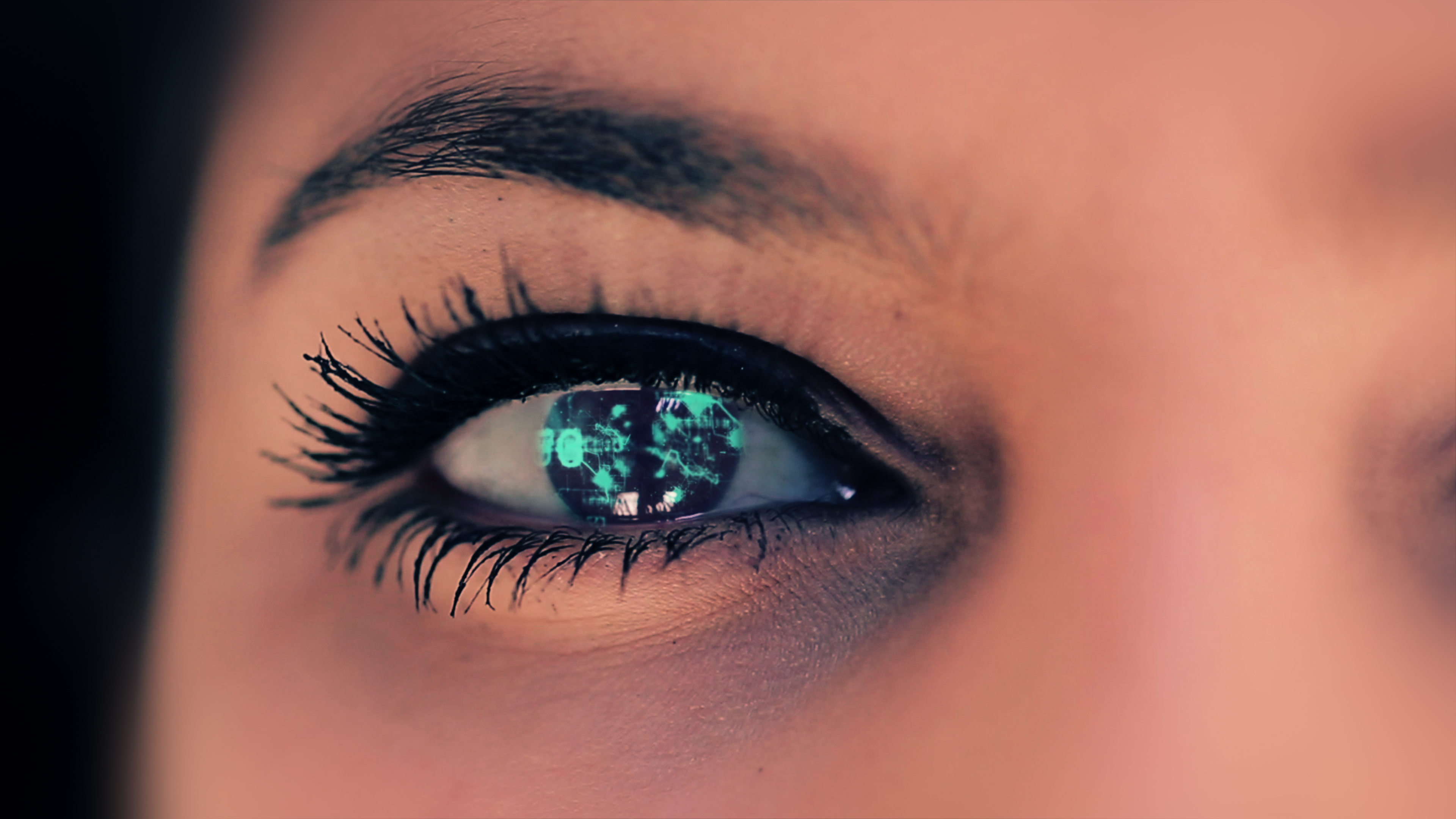 A decorative photo of a human eye. The iris is overlayed with neon, technical-looking patterns