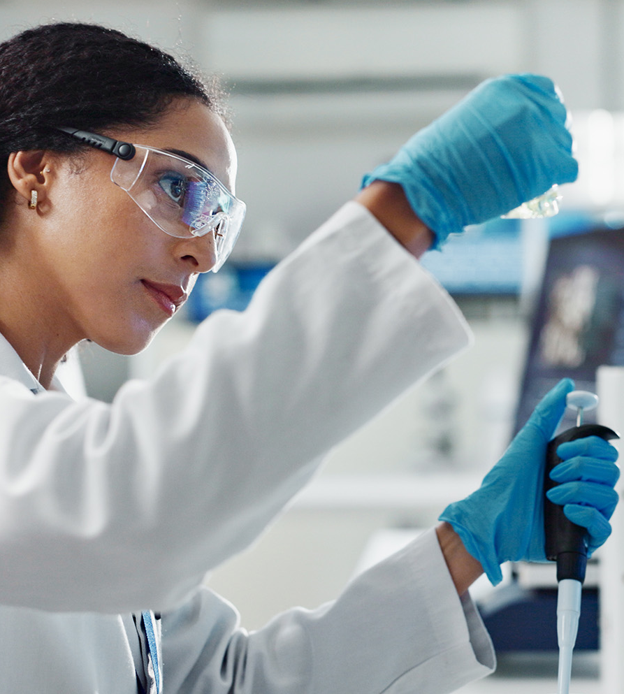A researcher working with beakers.