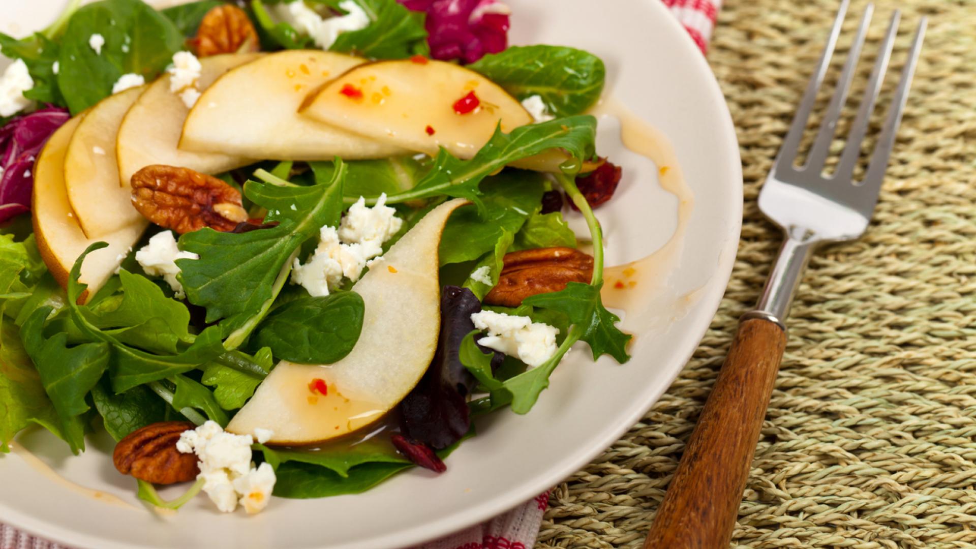 A bowl of pear and blue cheese salad.