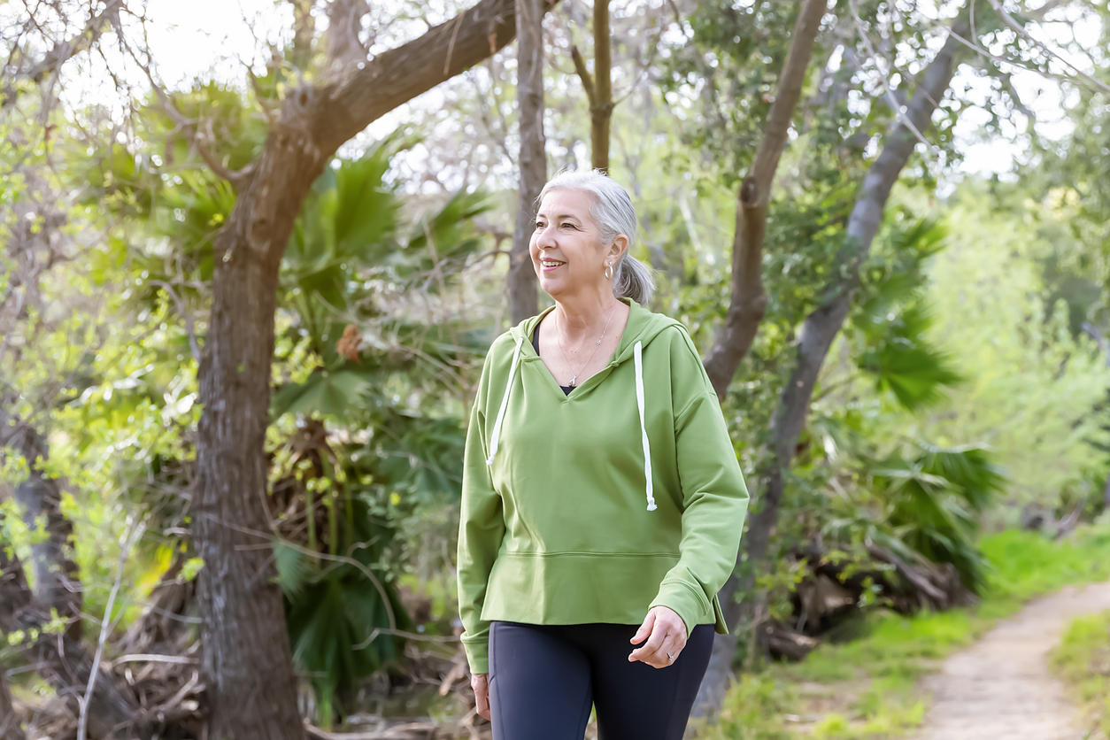 Woman walking on a nature trail.
