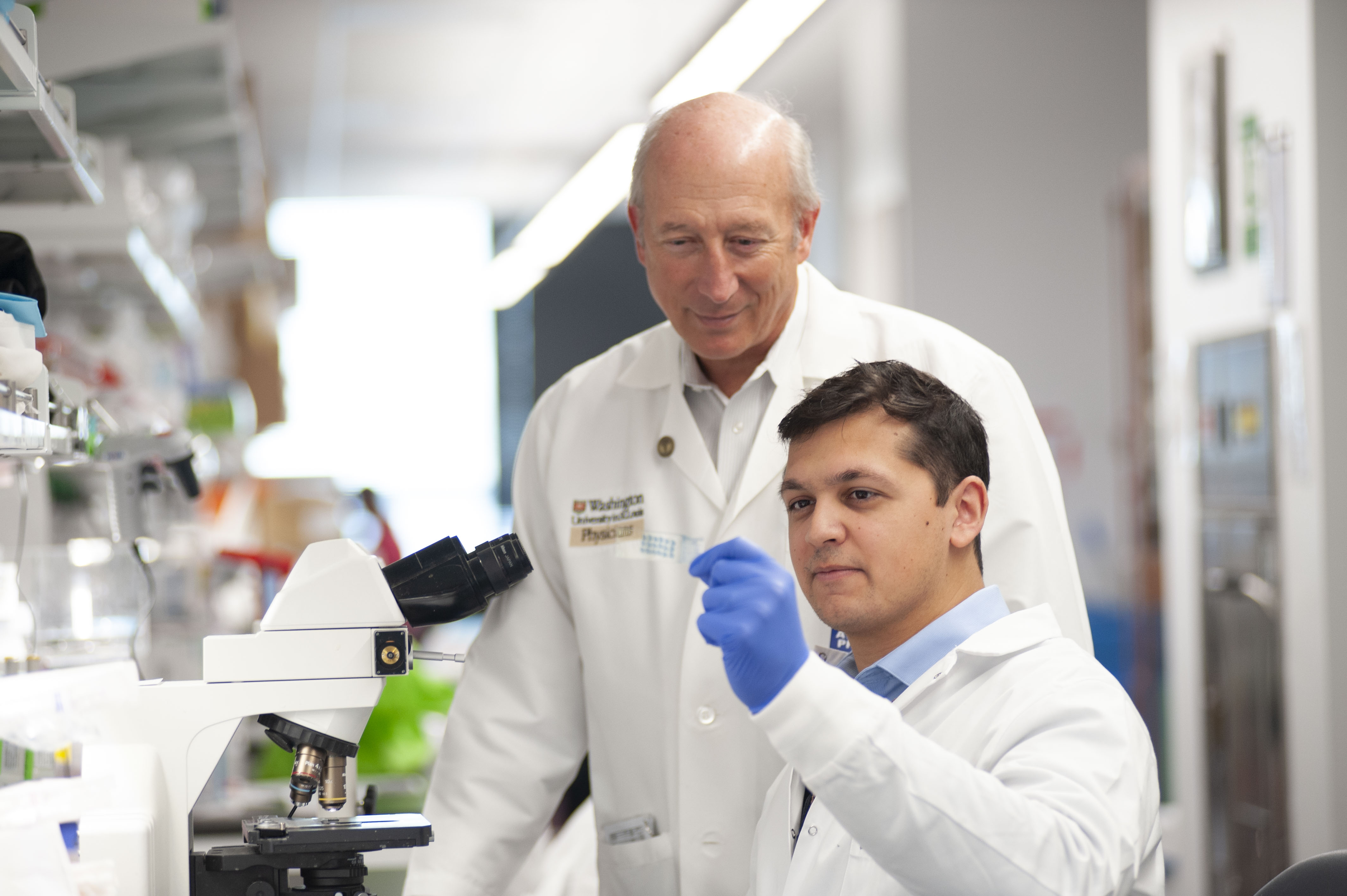 Dr. Holtzman and Dr. Emmerson working in a lab.