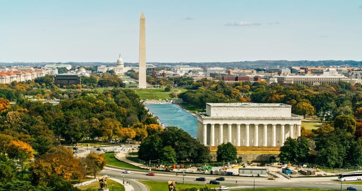 Helicopter shot of the the National Mall in Washington, D.C. on a sunny day in Fall, looking over the Lincoln Memorial and past the Washington Monument Towards Capitol Hill.