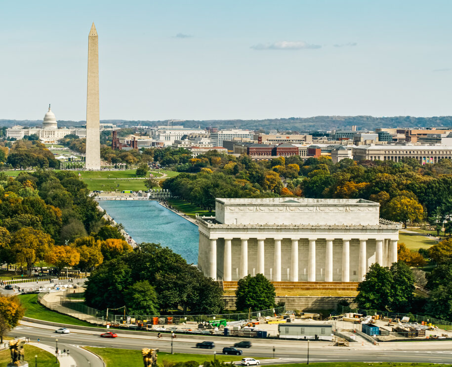 Helicopter shot of the the National Mall in Washington, D.C. on a sunny day in Fall, looking over the Lincoln Memorial and past the Washington Monument Towards Capitol Hill.