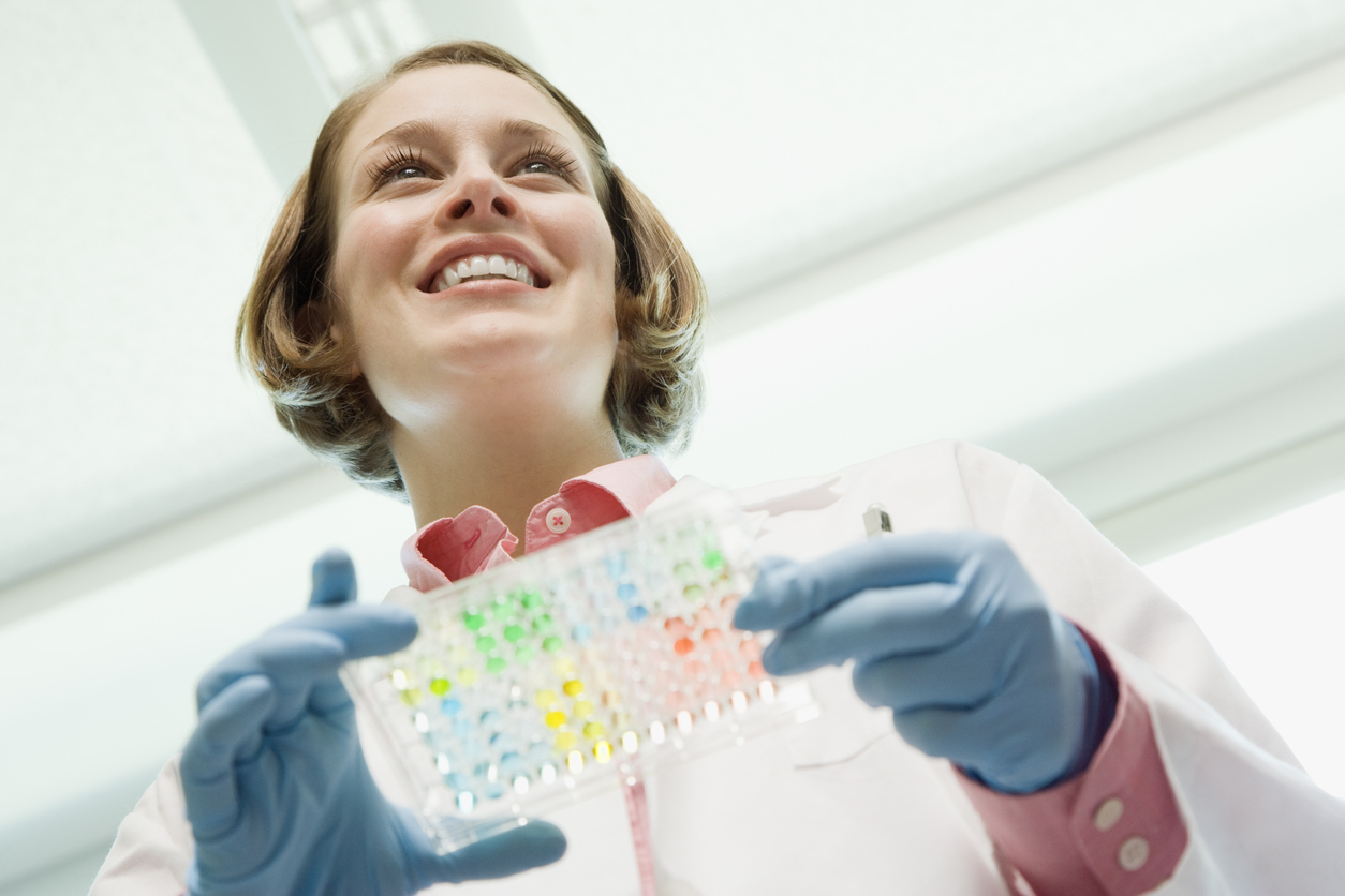 Scientist holding medical samples in laboratory.