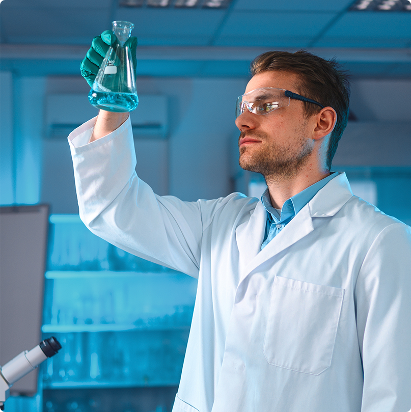 Scientist in a laboratory examining a flask of blue liquid while promoting glaucoma research donation campaign.