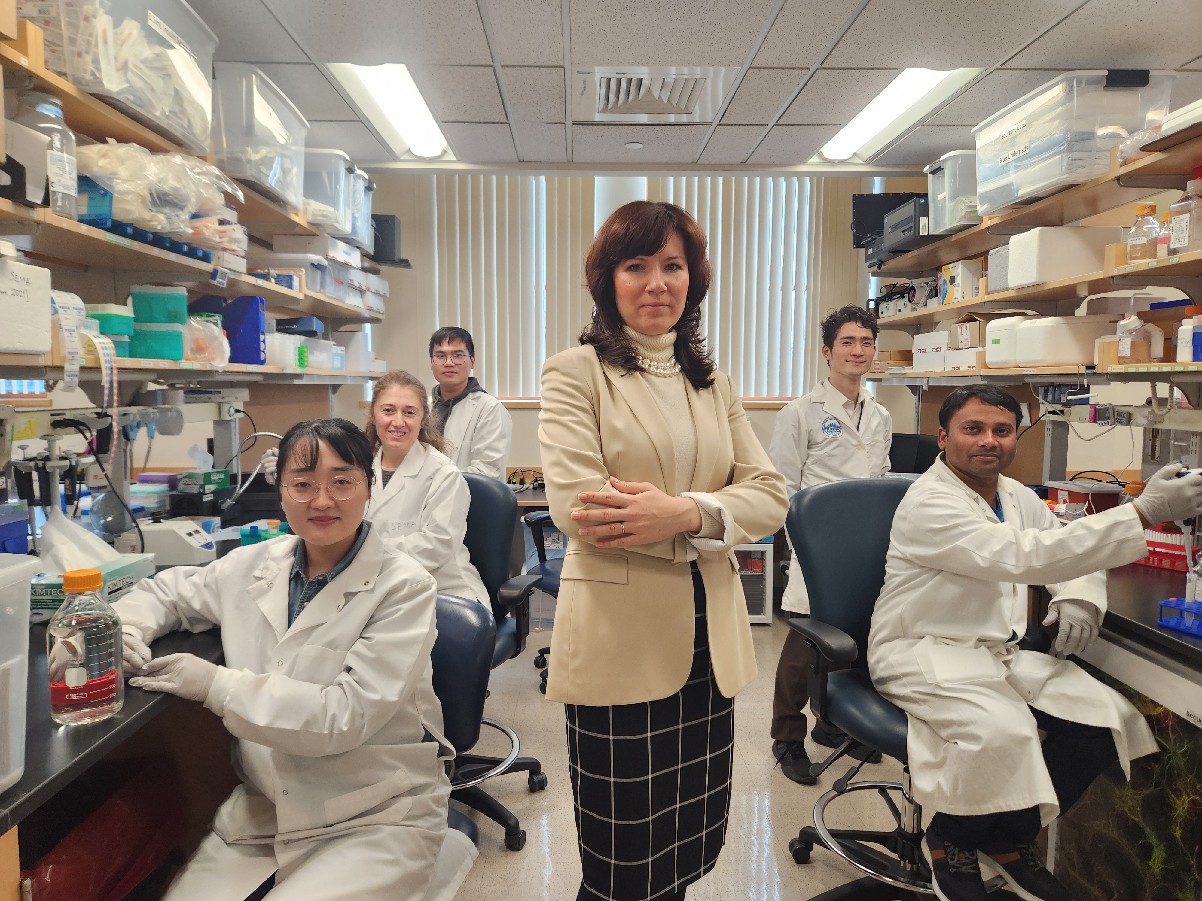 Ksenia Kastanenka, PhD (center) with team in lab.